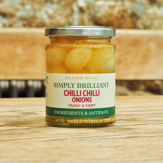 Jar of 'Simply Brilliant Chilli Pickled Onions' on a wooden surface