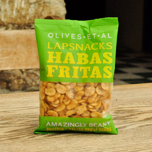 Green package of 'Habas Fritas' beans on a wooden surface