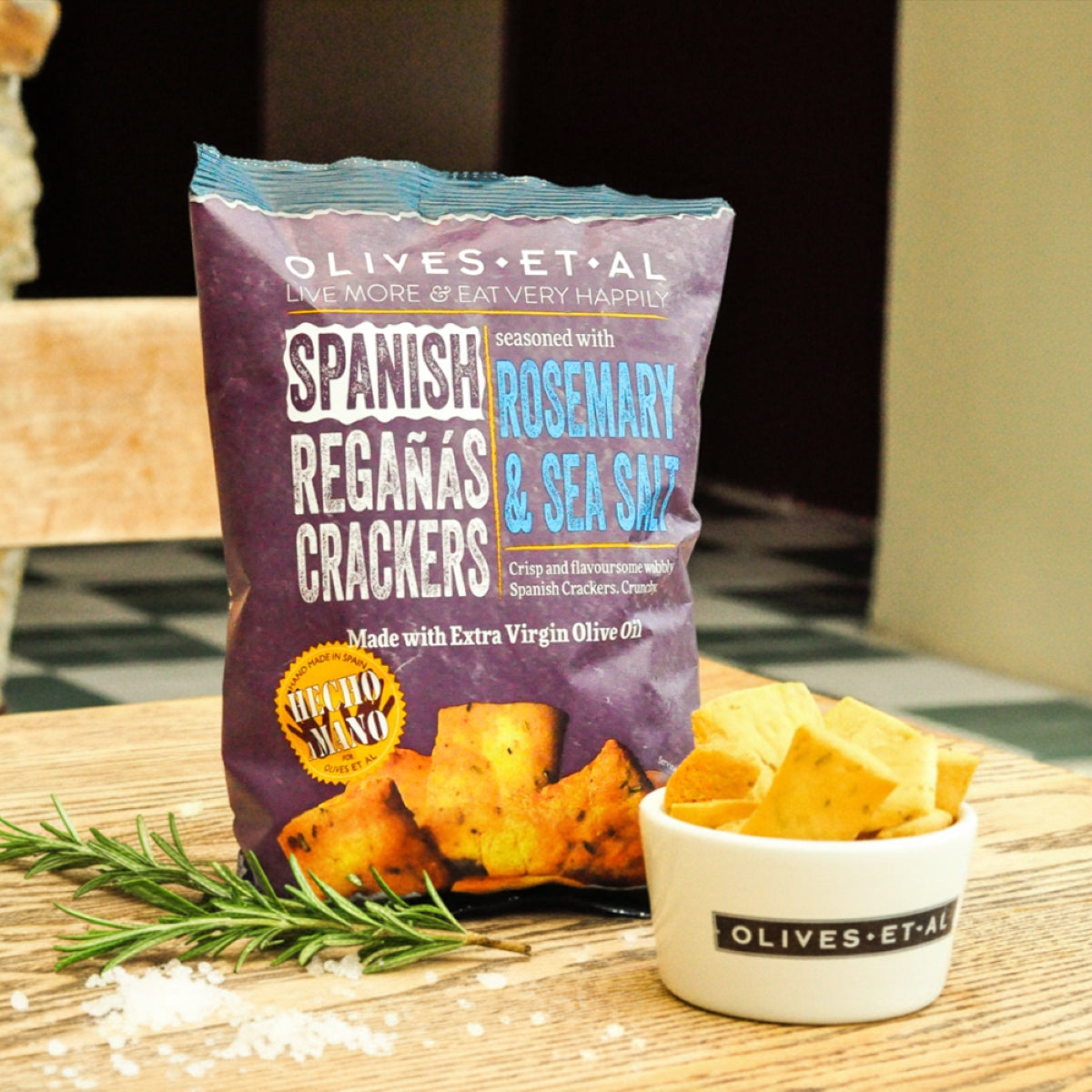 Bag of Spanish Regánñas Crackers with a small bowl of crackers on a wooden surface.