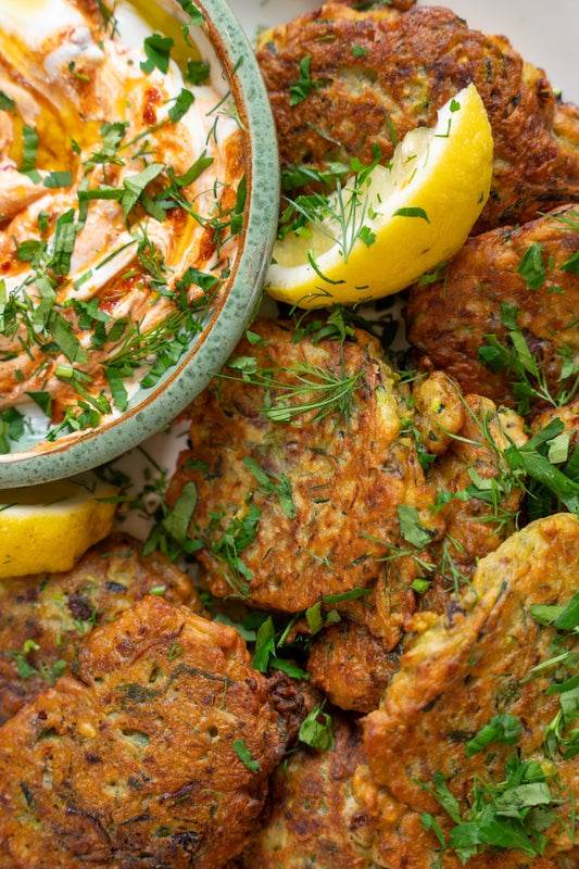 Golden courgette and olive fritters served with harissa yoghurt