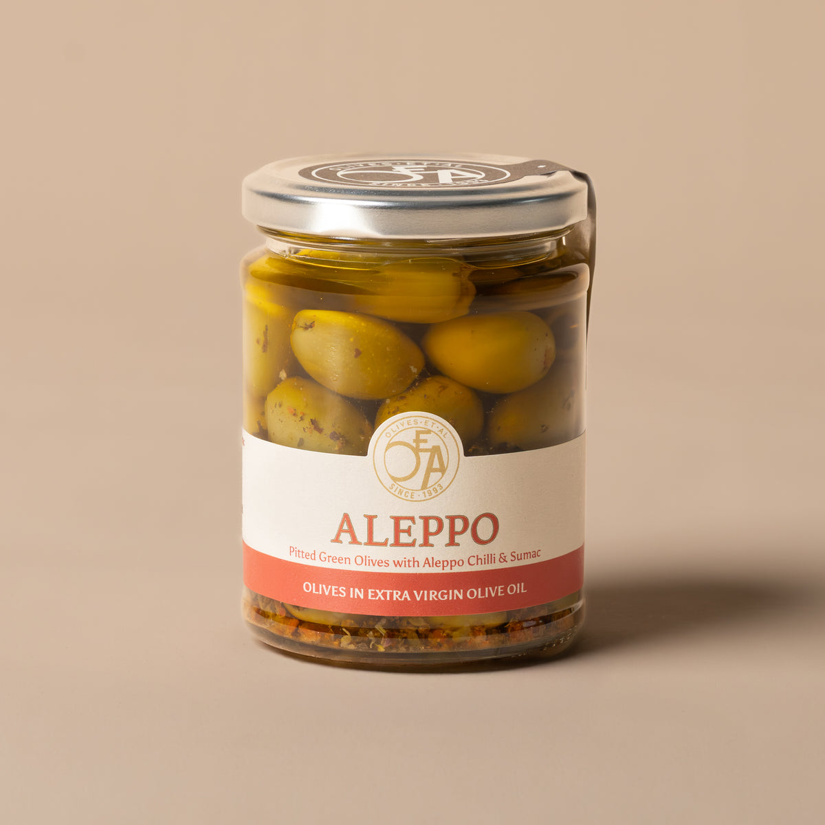 Jar of Aleppo green pitted olives in Extra Virgin Olive Oil