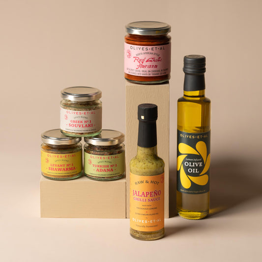 Olives Et Al BBQ Marinades Bundle featuring a flavour-packed selection of bottles, jars and seasonings for marinating and grilling. The bundle includes fragrant Lemon Olive Oil, adding bright citrus flavour to meat, fish and vegetables, alongside savoury spice blends inspired by Mediterranean and Middle Eastern cooking. Souvlaki Greek grilling spices combine aromatic herbs and seasonings, while Shawarma Levantine spices deliver warm, fragrant depth and Adana Turkish kebab seasoning brings bold, savoury char