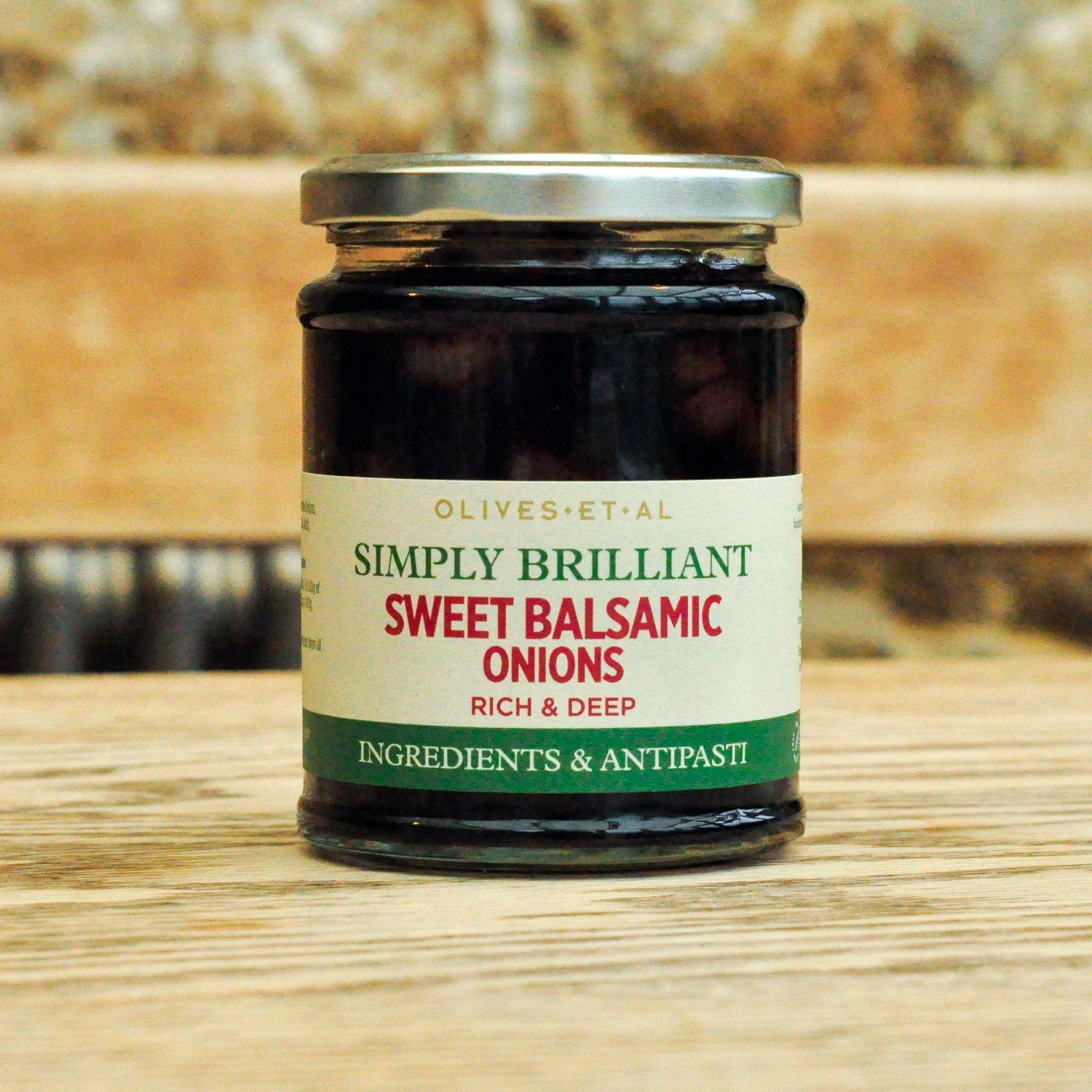 Jar of 'Simply Brilliant Sweet Balsamic Onions' on a wooden surface