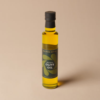Olives Et Al Basil Olive Oil in a 250ml glass bottle, filled with golden extra virgin olive oil infused with fragrant basil. Made with 99% extra virgin olive oil, basil and basil aroma, this green-flecked oil adds fresh herbal flavour to festive cooking. Perfect for Christmas gifting, it brings a Mediterranean touch to seasonal salads, bruschetta, roast vegetables, pasta and warm bread. A thoughtful stocking filler or gourmet gift for food lovers who enjoy tasty oils, homemade meals and festive entertaining