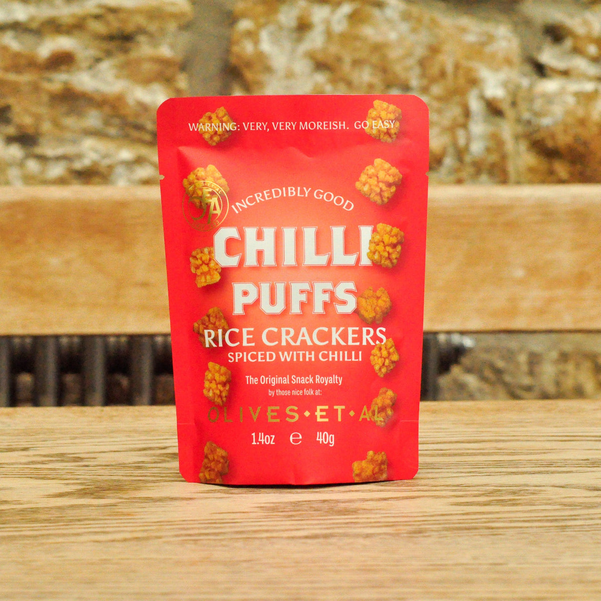 Olives Et Al Chilli Puffs, spiced chilli rice crackers on wooden table