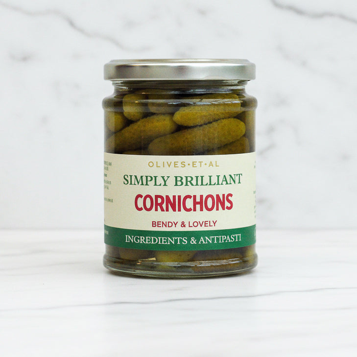 Jar of cornichons with a label on a white background