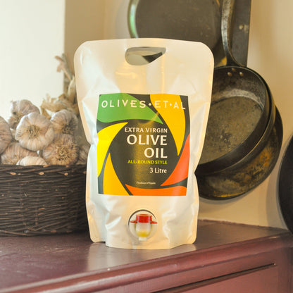 3-liter bag of extra virgin olive oil with 'Olives et Al' branding on a wooden surface.