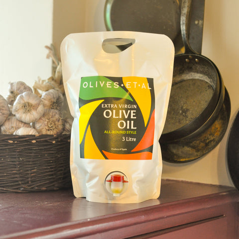 3-liter bag of extra virgin olive oil with 'Olives et Al' branding on a wooden surface.