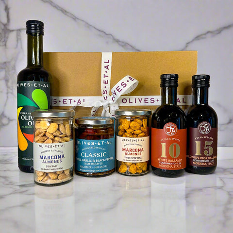 Collection of olive oil bottles and jars with 'Olives et Al' branding on a neutral background.