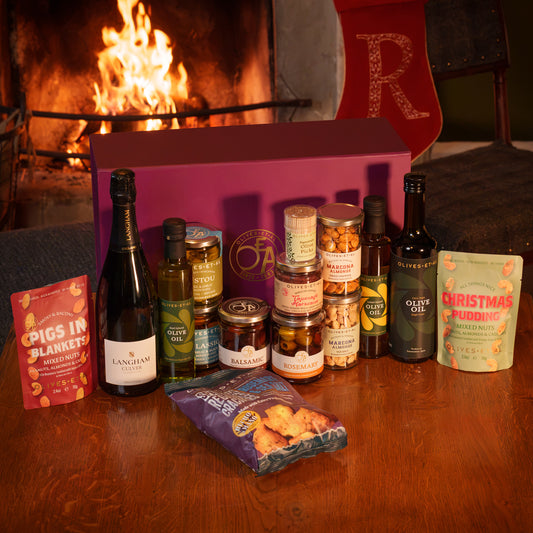 Olives Et Al Grand Christmas Hamper in a large purple gift box, featuring Langham Culver Classic Cuvée, House, Basil and Lemon Olive Oils, and jars of Classic, Rosemary, Pistou and Balsamic Olives. Includes Tapenade Marocaine, lightly salted and sweet paprika Marcona almonds, Christmas Pudding Mixed Nuts, Pigs in Blankets Roasted Nuts, Rosemary & Sea Salt Regañas crackers and olive picks. A generous Christmas gift for food lovers, perfect for festive aperitifs, party nibbles and sharing with family and pals