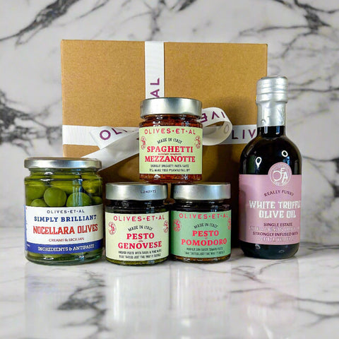 Collection of Olives Et Al food products including jars and a bottle on a neutral background
