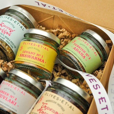 Jars of spices labeled 'Olives et al' in a box