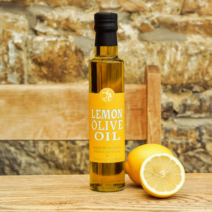 Bottle of lemon olive oil with a lemon on a wooden surface
