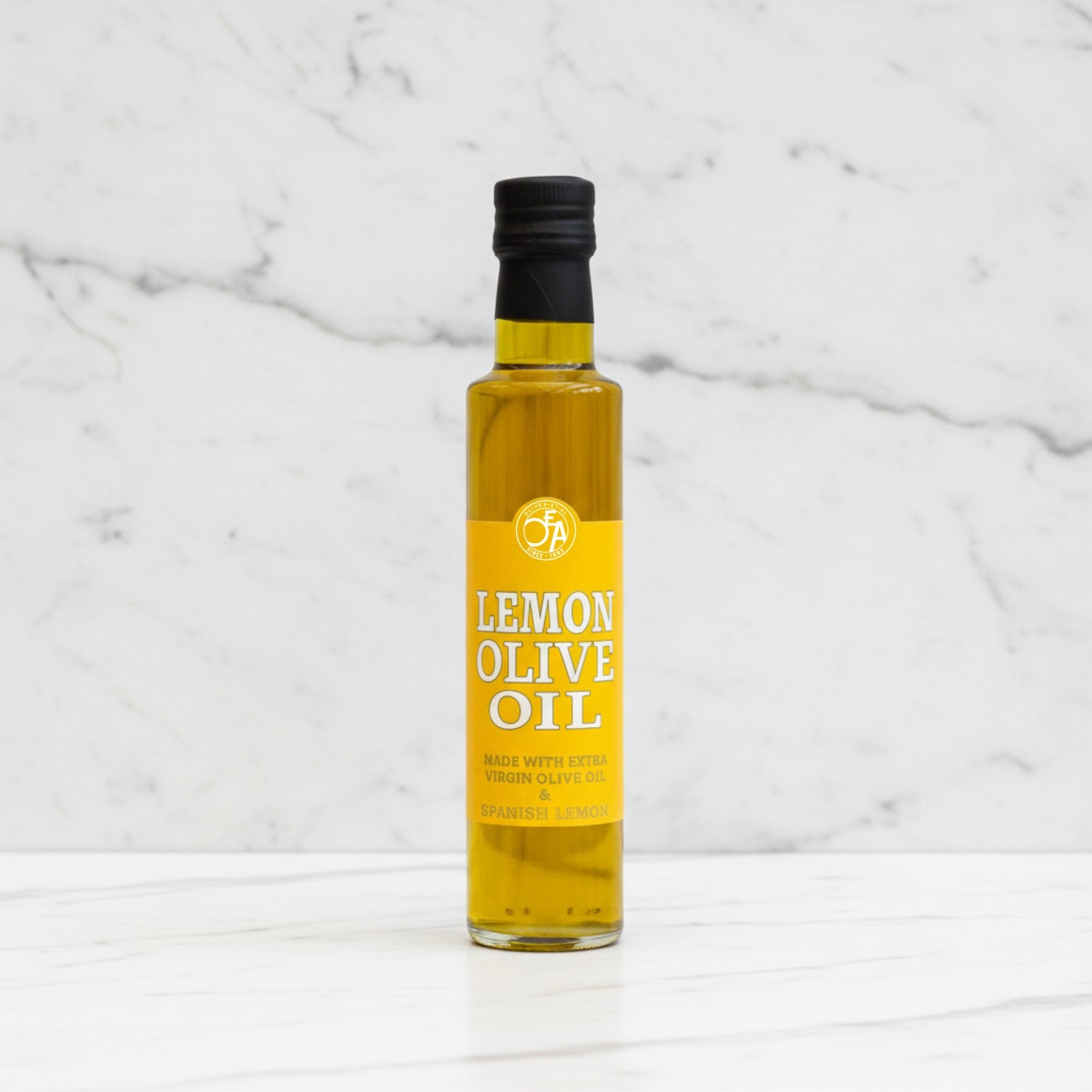 Bottle of lemon olive oil on a marble background
