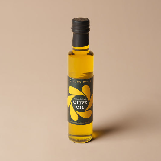 Olives Et Al Lemon Olive Oil in a 250ml glass bottle, filled with Spanish extra virgin olive oil infused with lemon aroma for a fresh citrus finish. The branded bottle makes a thoughtful Christmas stocking filler or gourmet gift for cooks. Ideal for festive feasts, this fragrant oil adds a fresh twist to roast vegetables, grilled fish, winter salads and homemade dressings. Drizzle over Christmas starters, use in marinades or pair with crusty bread for a simple seasonal treat to share with family and friends
