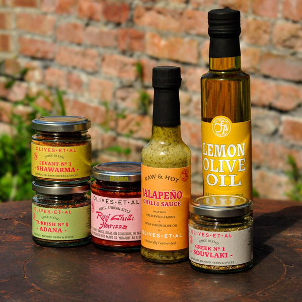 BBQ marinades bundle on a bbq with brick wall in background