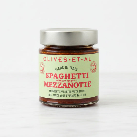 Jar of spaghetti mezzanotte with a green label on a white background