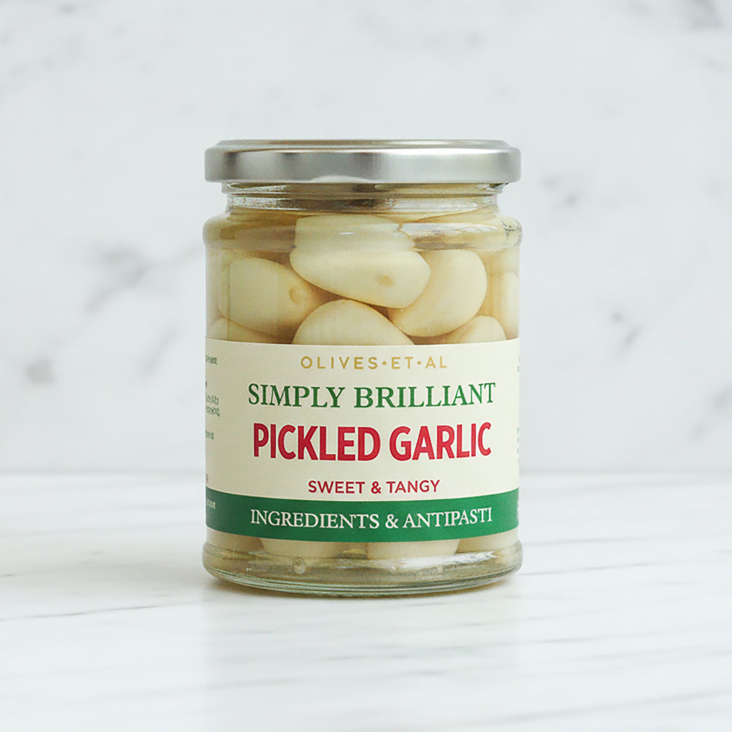 Jar of pickled garlic with a visible label on a white background