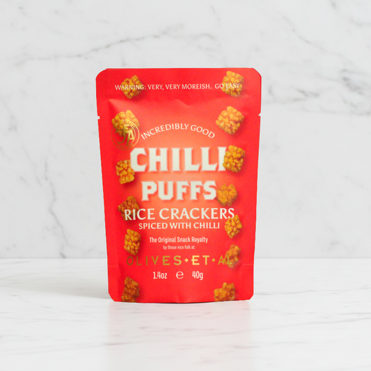 Olives Et Al Chilli Puffs on white marble background