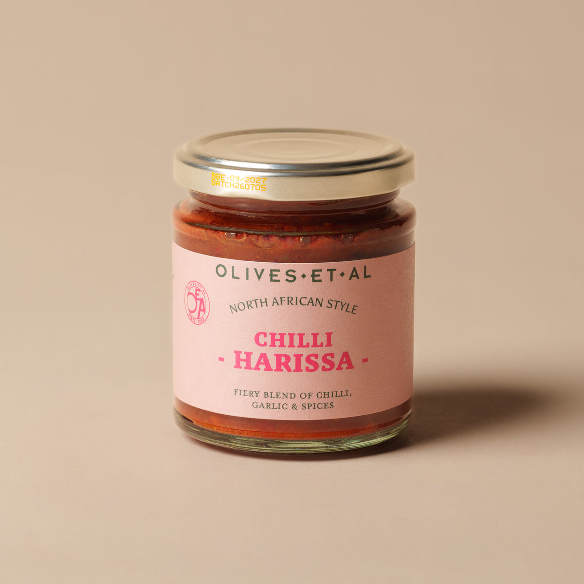 Olives Et Al Harissa North African Chilli Paste in a 180g glass jar, filled with a rich red, fiery blend of 31% red chilli, 23% garlic, onion, smoked paprika, ginger, coriander, cumin and fennel seeds. This fragrant, gently smoky paste brings warmth to Christmas cooking, from roasted vegetables and festive dips to spiced lamb, chicken and halloumi. A thoughtful stocking filler or gourmet Christmas hamper addition for adventurous food lovers, perfect for adding bold flavour to seasonal meals and party nibble