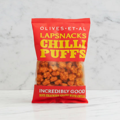Bag of Olives Et Al Lapsnacks Chilli Puffs on a marble background