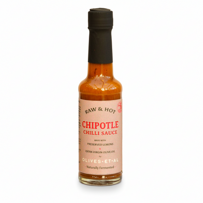 Bottle of chipotle chili sauce with a black cap on a white background