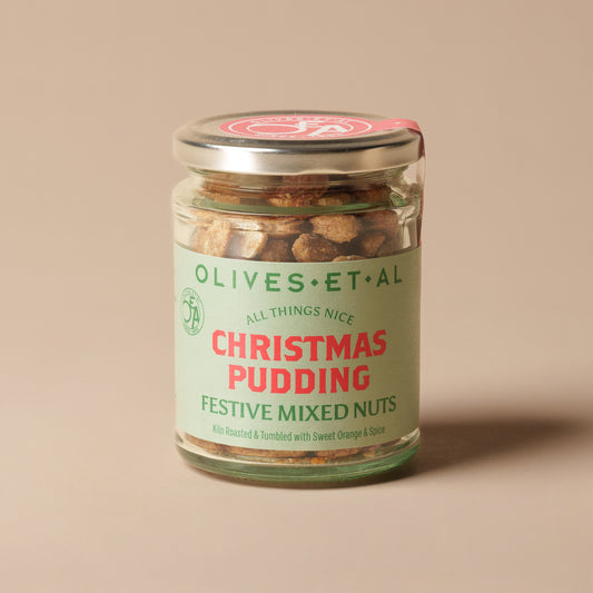 Olives Et Al Christmas Pudding Mixed Nuts, a festive mix of kiln-roasted peanuts, almonds and cashews coated with orange, warming cinnamon, nutmeg and a touch of sweetness. Roasted in Dorset without seed oils, these crunchy, sweetly spiced nuts capture the comforting flavours of traditional Christmas pudding. Perfect for Christmas gifting, stocking fillers and festive hampers, they make a delicious treat for seasonal gatherings, cheeseboards, after-dinner nibbles or sharing with loved ones over a warm drink
