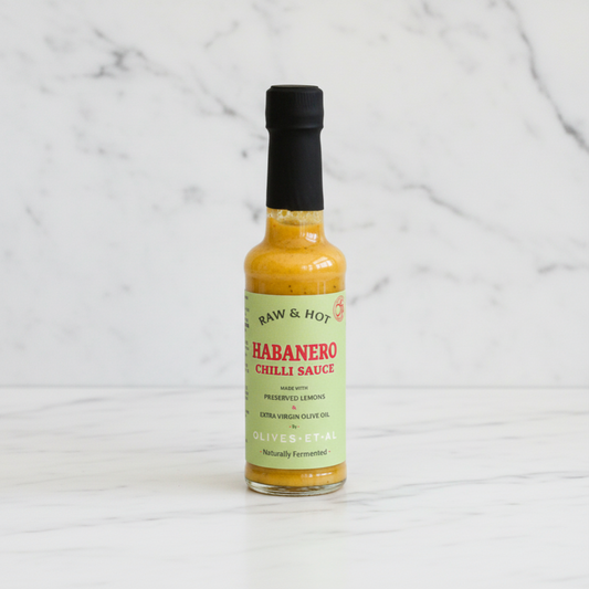 Raw & Hot, naturally fermented habanero chilli sauce on white marble background