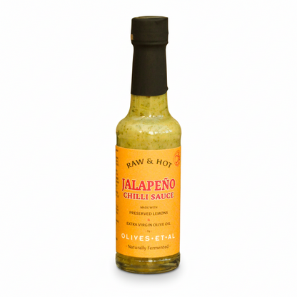 Bottle of Jalapeño chili sauce with a yellow label on a white background