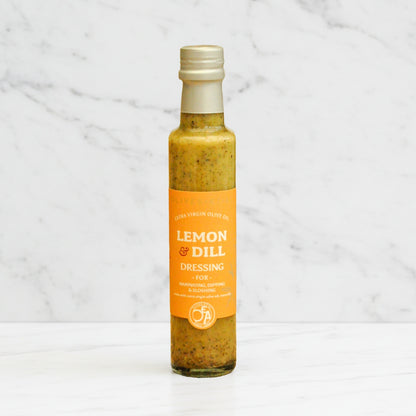 Bottle of Lemon & Dill dressing on a marble background