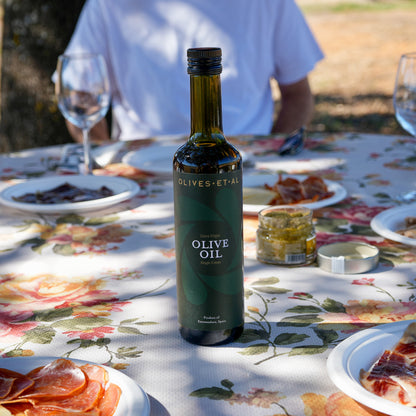 Olives Et Al House Extra Virgin Olive Oil 500ml bottle on an outdoor dining table