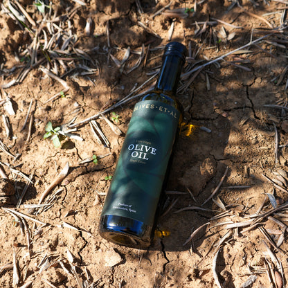 Olives Et Al House Extra Virgin Olive Oil 500ml bottle on the earth in an olive grove