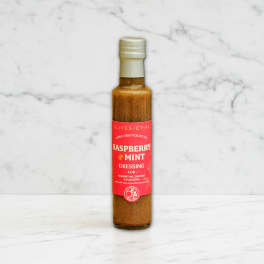 Bottle of raspberry and mint dressing made with 100% extra virgin olive oil, UK-made fruity salad dressing with no seed oils